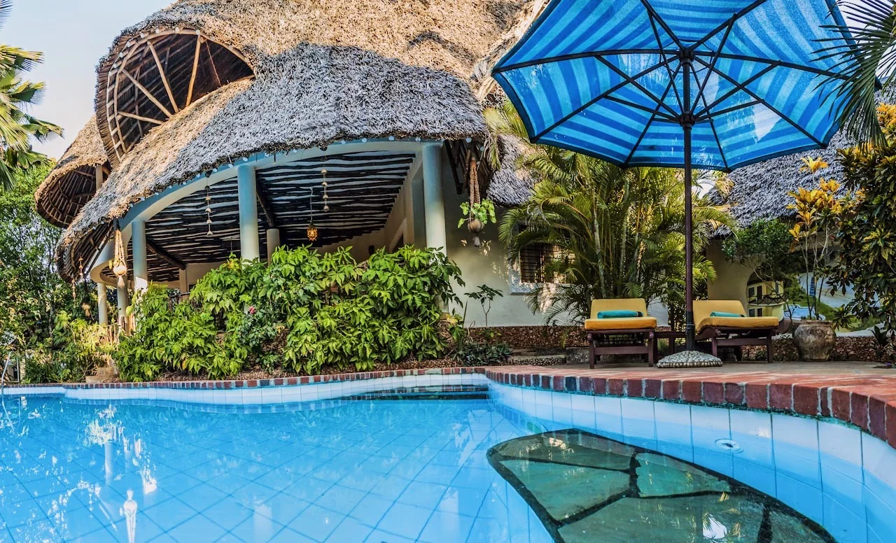 Poolside view with blue striped umbrella